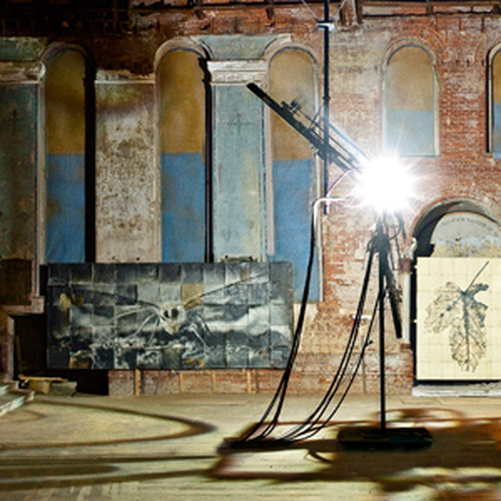 The carbon arc lamp and large moth print inside the brick church.