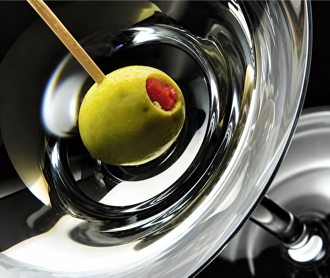 Close-up of a martini glass with a green olive on a cocktail pick. (Digitally enhanced. May contain discrepancies from the original artwork.)