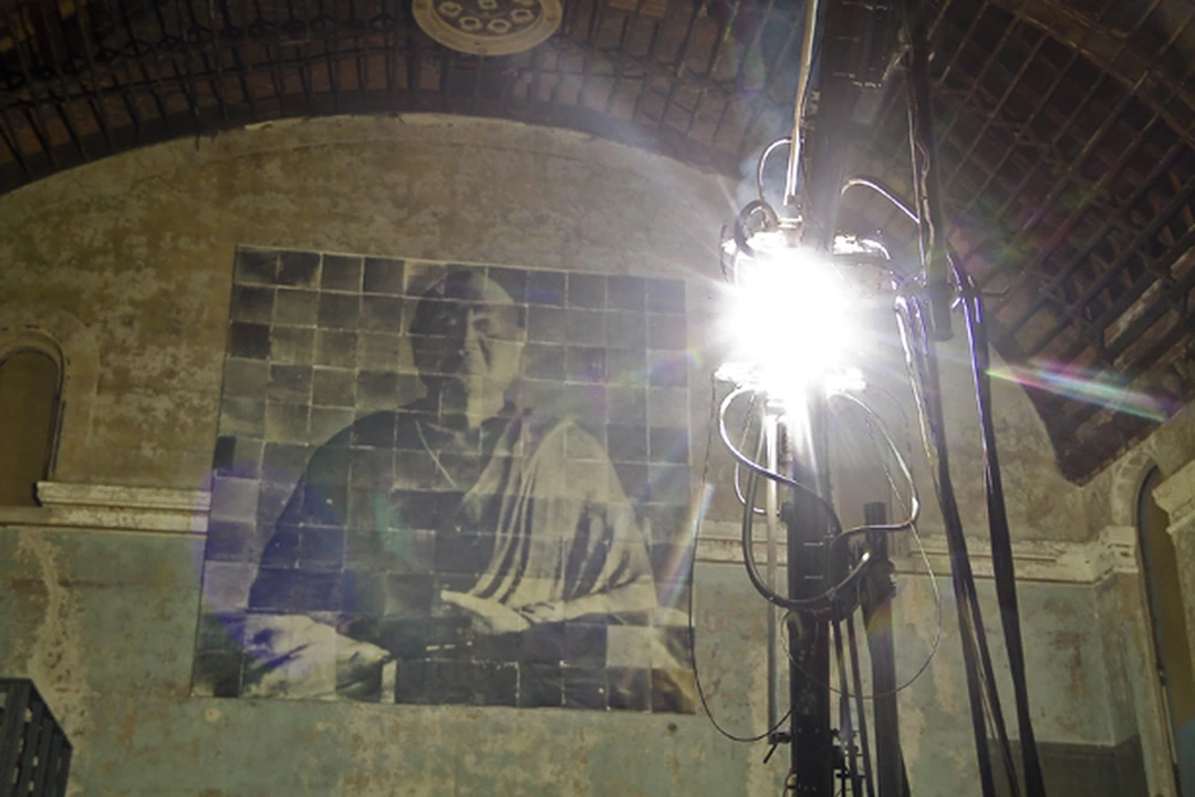 Doug and Mike Starn, Gravity of Light, installation view with carbon arc lamp and monumental multi-panel portrait of the Buddhist monk Ganjin on the church wall, 2012