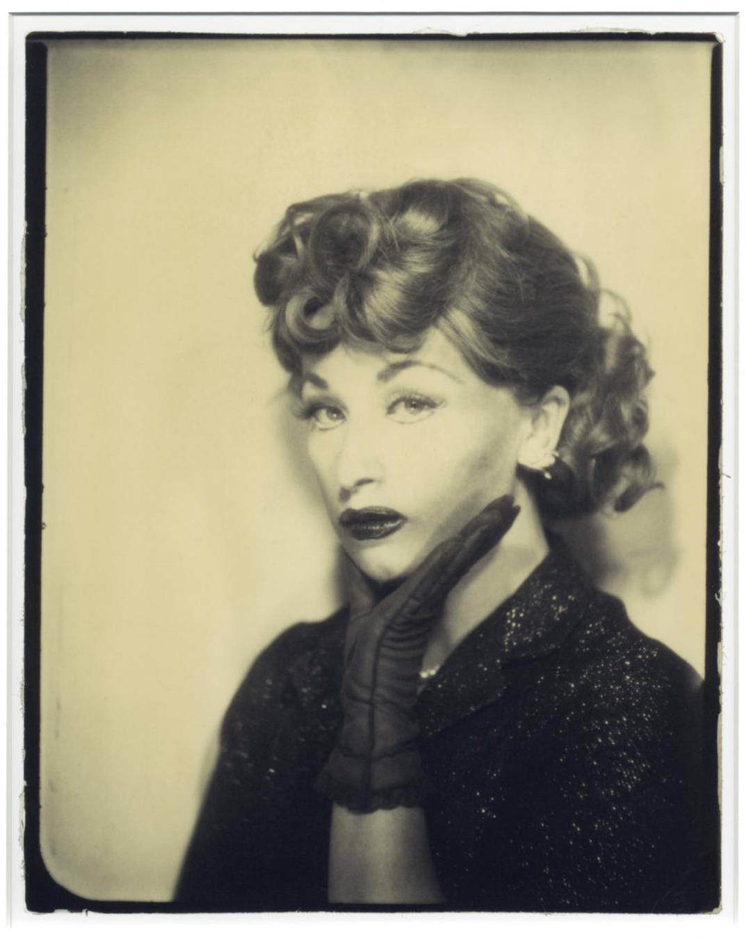 Cindy Sherman as Lucille Ball, a black-and-white self-portrait with curled hair and a gloved hand at her chin.