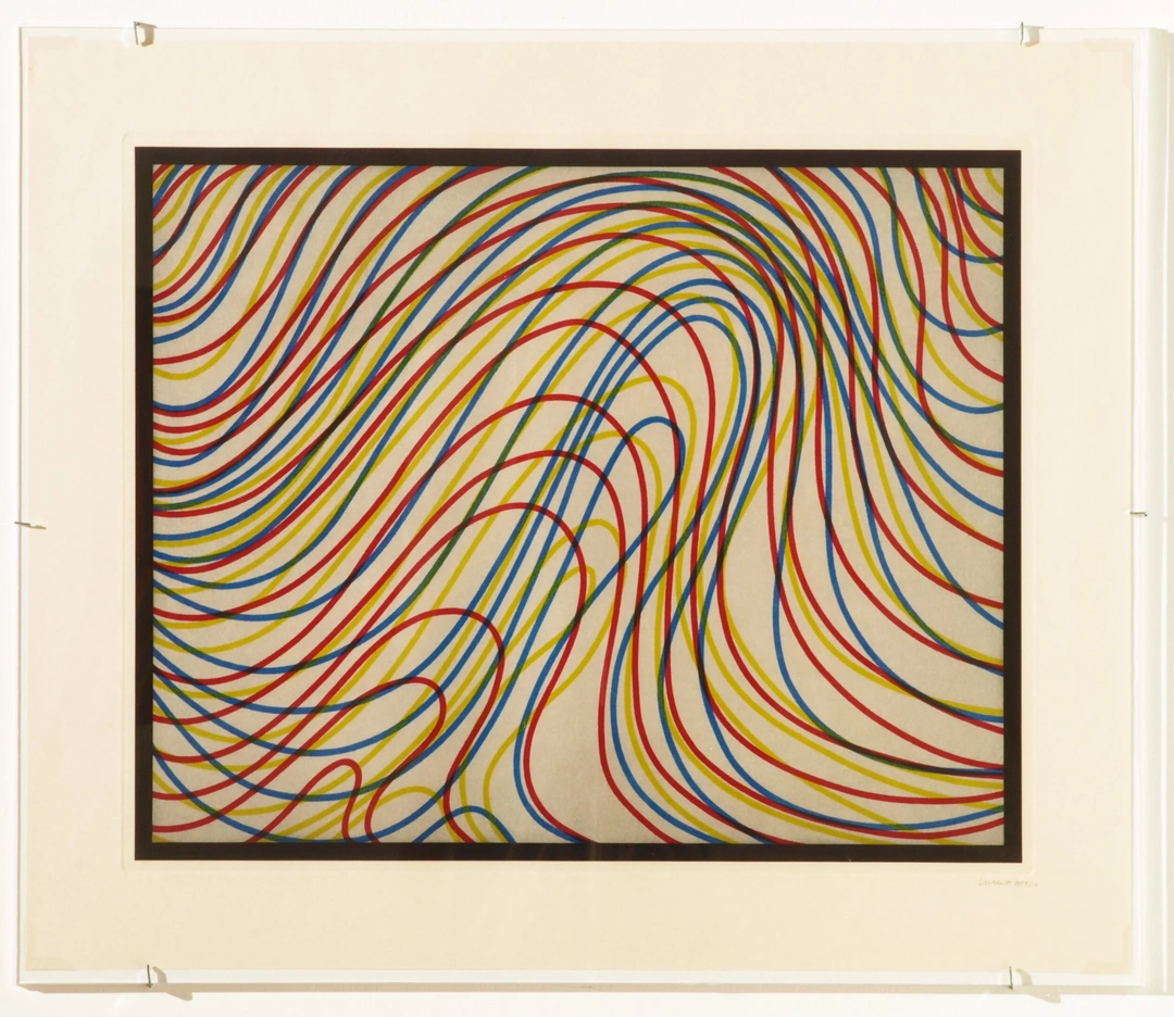 A framed print contains many thin red, blue, yellow and black lines sweeping into overlapping waves within a black rectangular border.