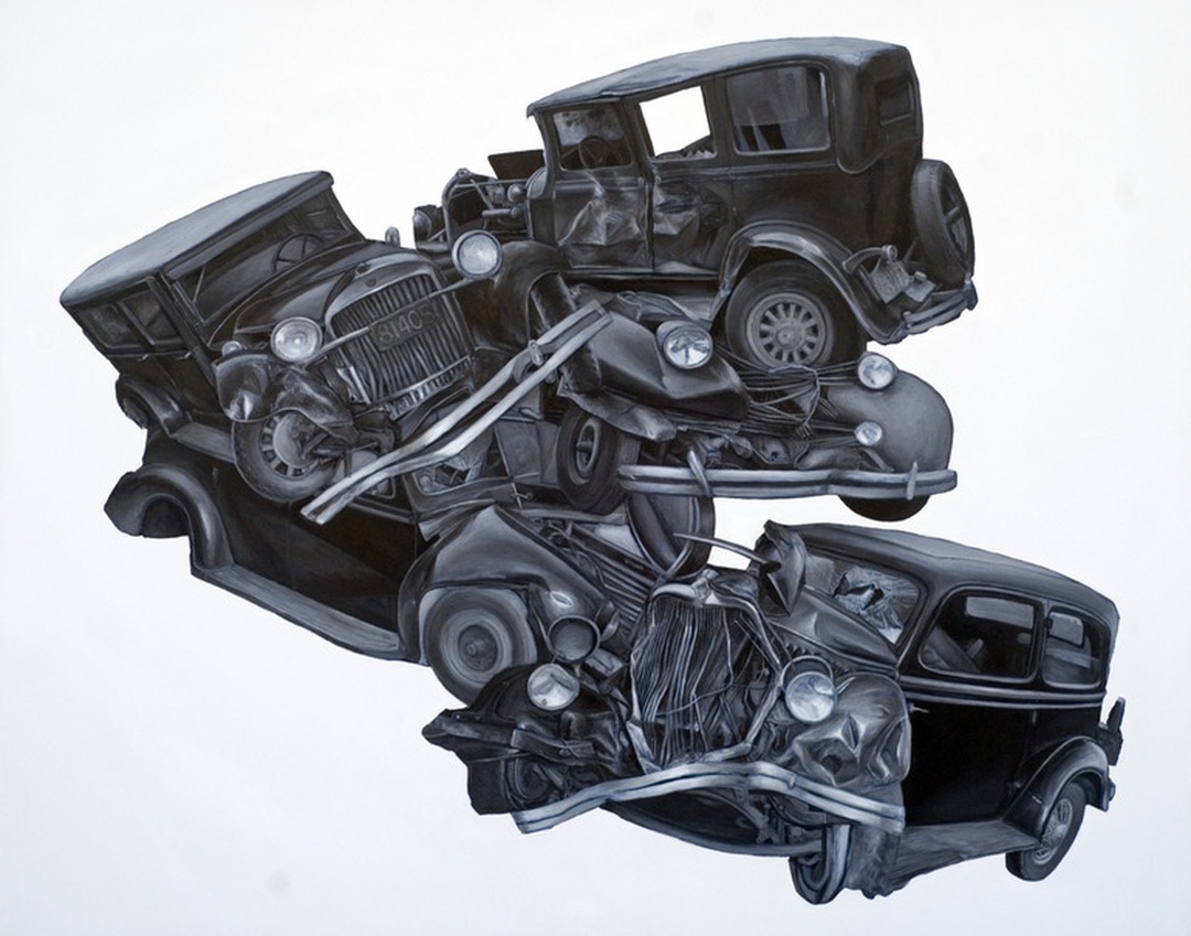 Pile of crashed vintage automobiles in black and white.