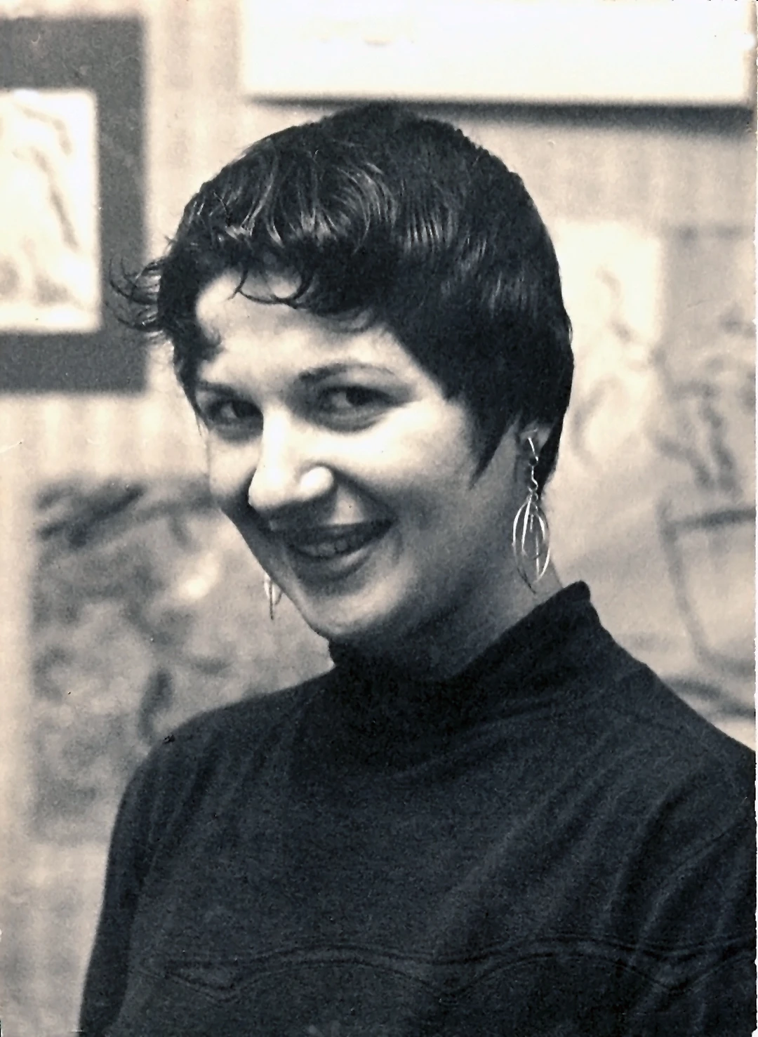 Black-and-white portrait of a smiling young Gloria Torrice with short dark hair and drop earrings.
