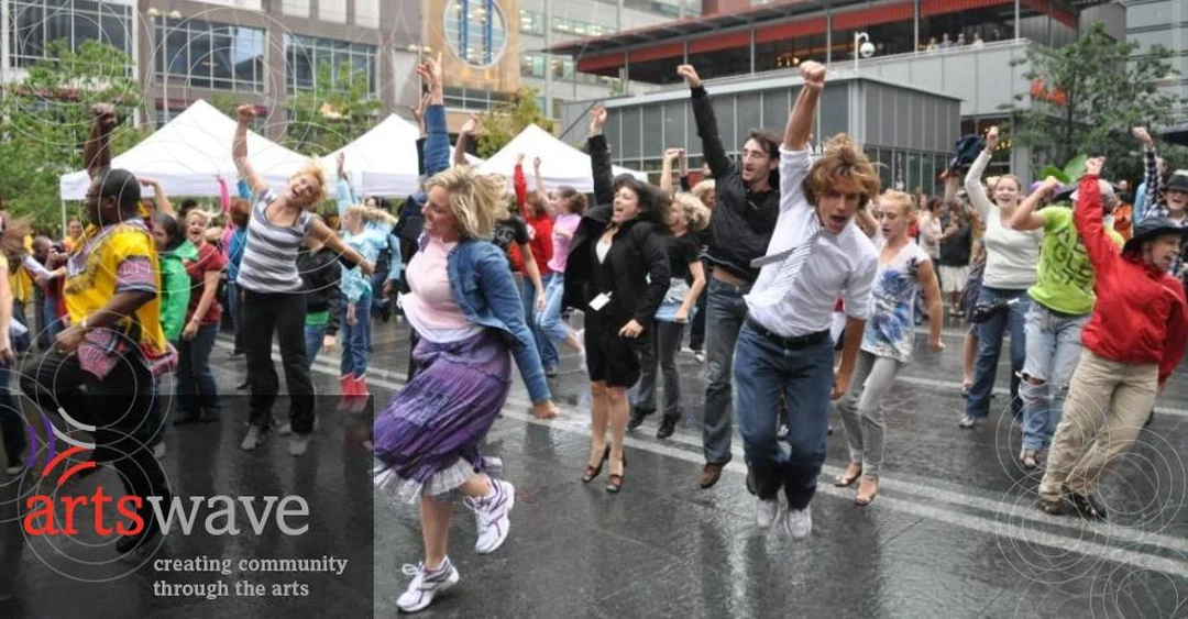 Crowd dancing at Fountain Square during an ArtsWave campaign event.