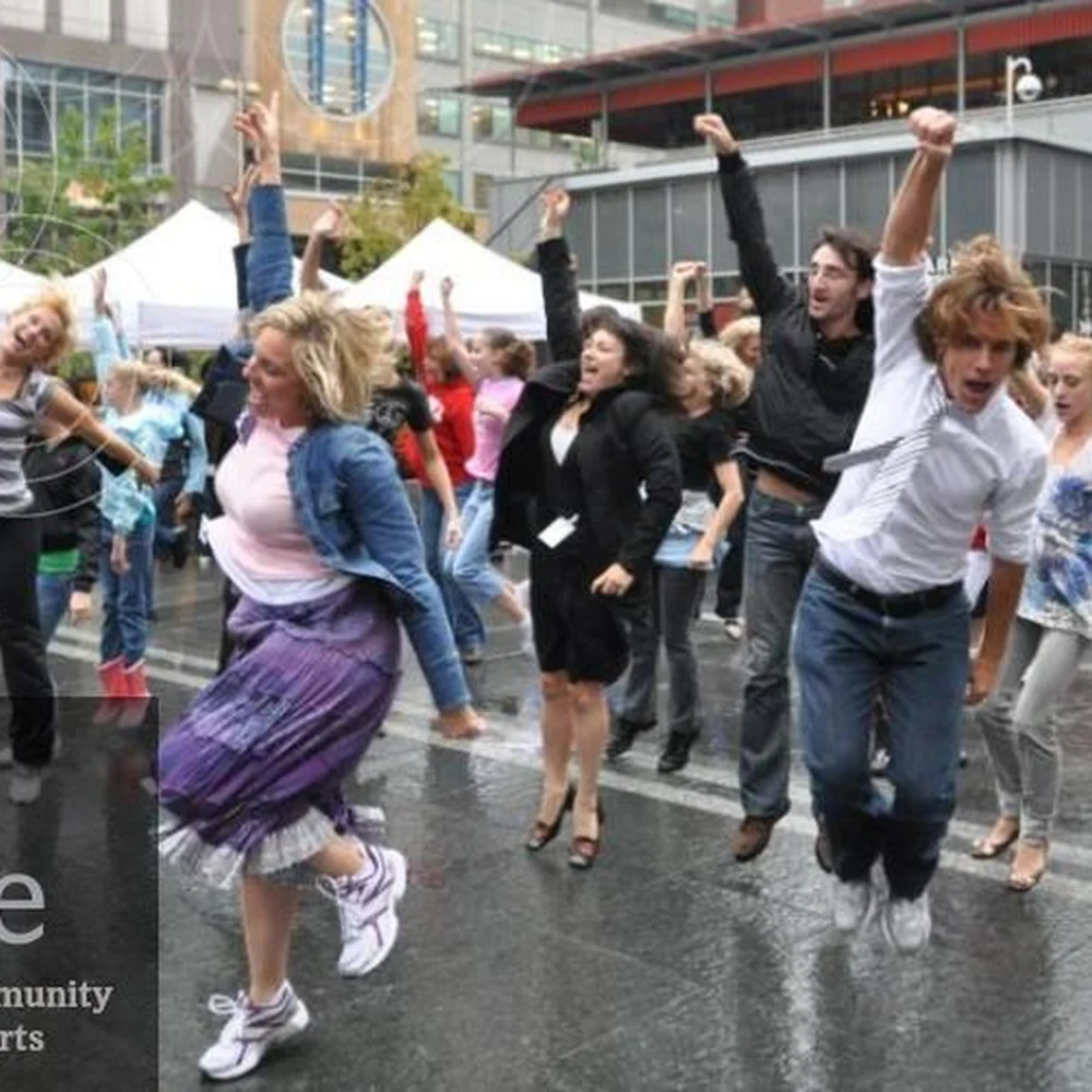 Crowd dancing at Fountain Square during an ArtsWave campaign event.