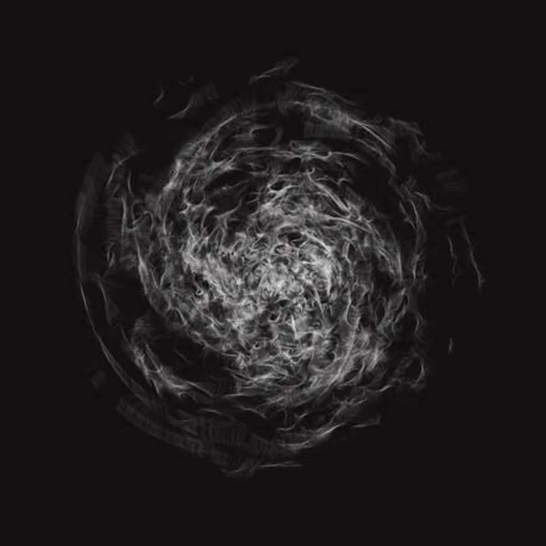Swirling white smoke-like circular form on a black background.