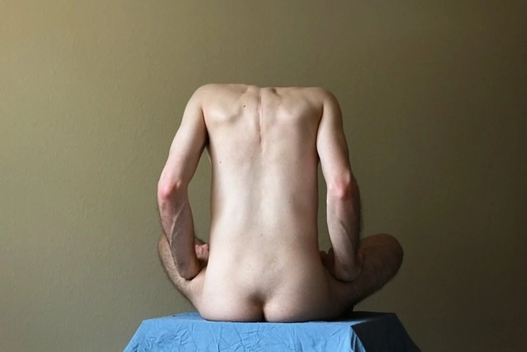 Photograph of a nude man seated seen from behind, by David Werkstatt