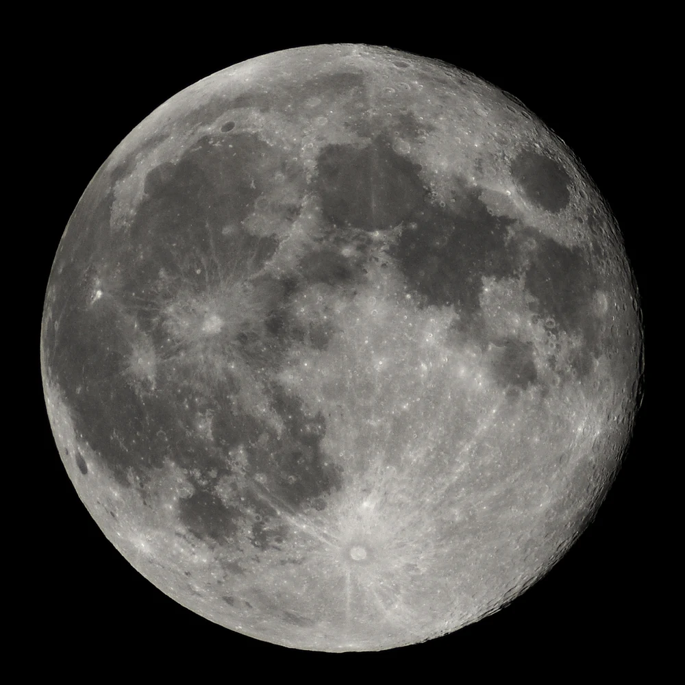 Full moon against a black sky, showing craters and maria