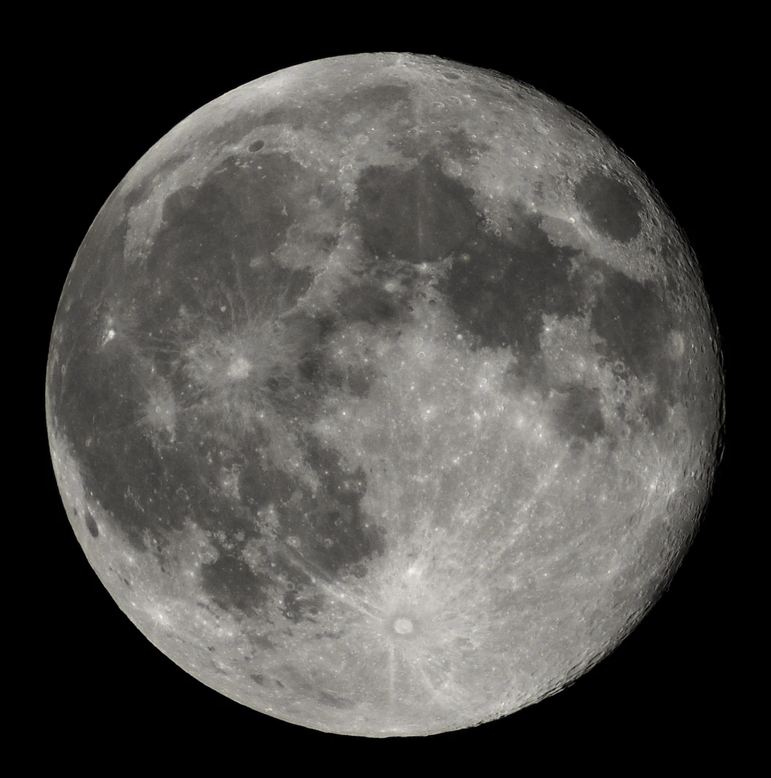 Full moon against a black sky, showing craters and maria