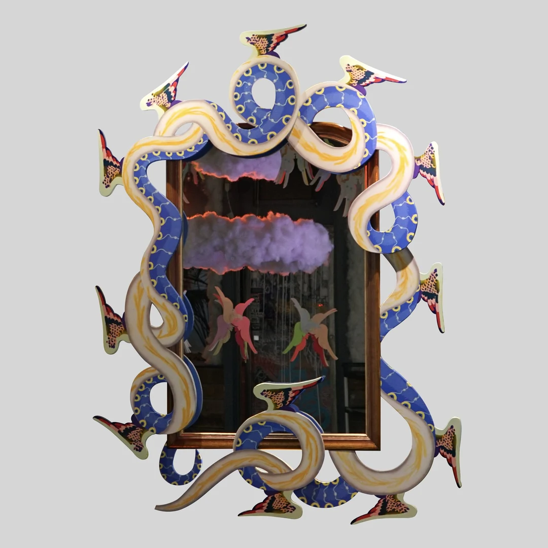 Colorful sculptural mirror entwined with blue and cream serpents and winged bird figures, reflecting a cloudy sky