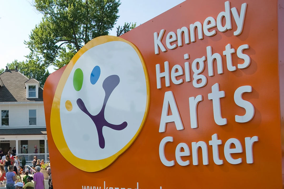 The Kennedy Heights Arts Center sign and historic mansion building during a community event.