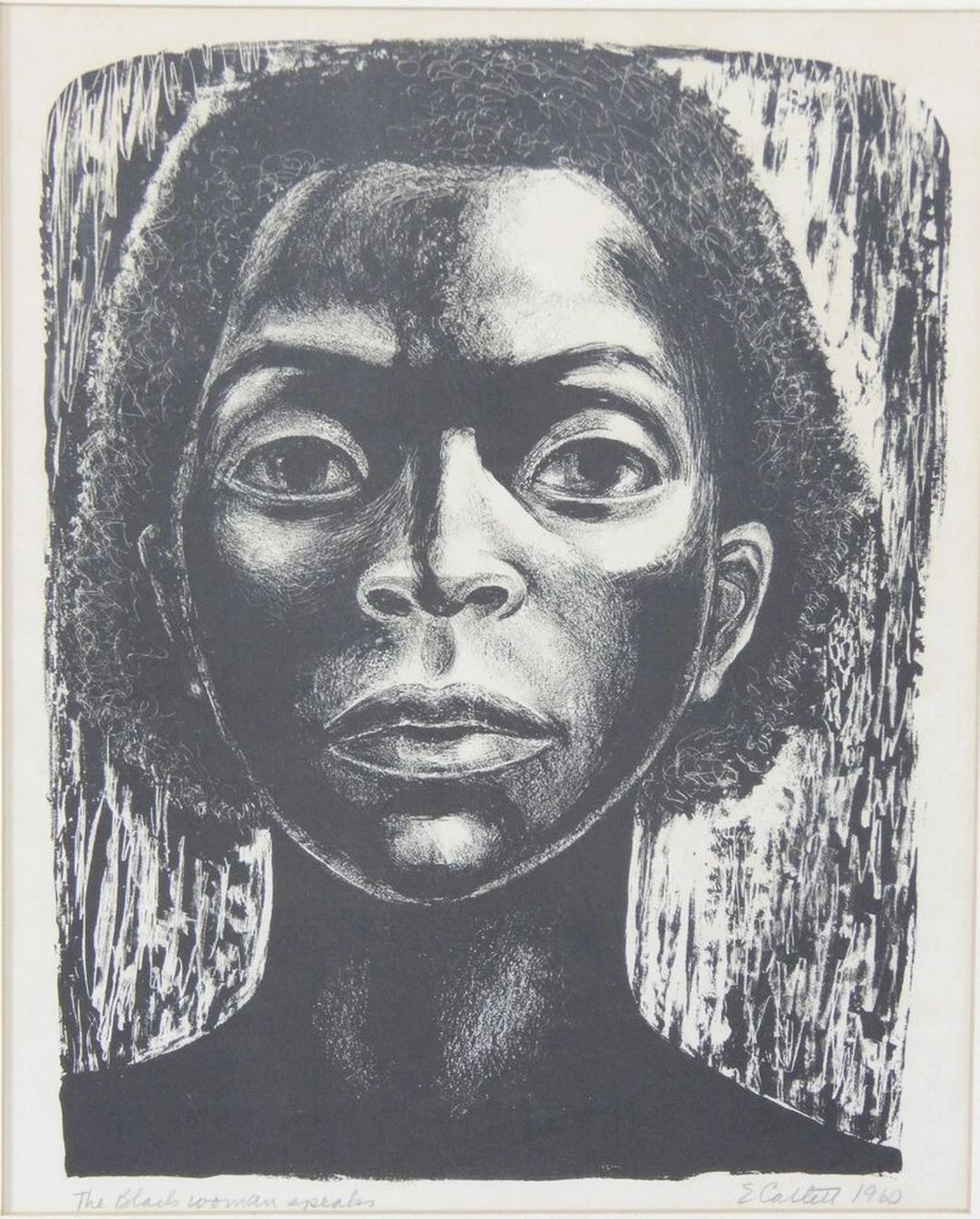 Black-and-white print by Elizabeth Catlett showing the close-cropped face of a woman, titled The Black Woman Speaks.