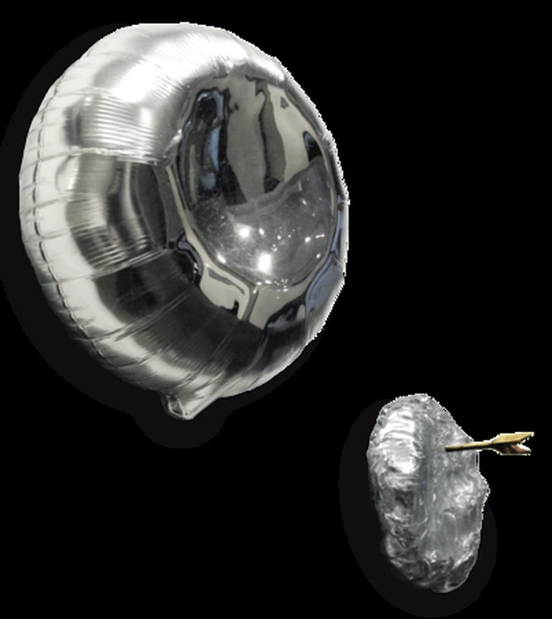 A mirrored glass balloon form beside a smaller crinkled one pierced by a golden arrow.