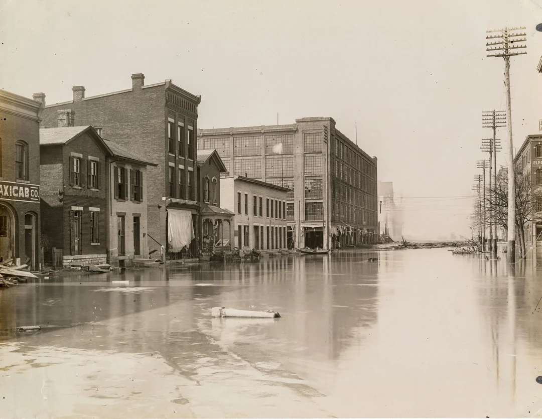 Flooded street with brick buildings on both sides, water reaching the storefronts. Image from Andy Snow's website.