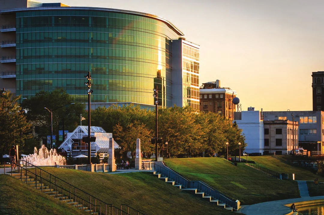 Dayton's riverfront at sunset with the curved glass CareSource building, fountain and steps down to the Great Miami River. Photograph by Andy Snow. Image from A Flood of Memories, 2013. (Related image located during this archive's reconstruction.)