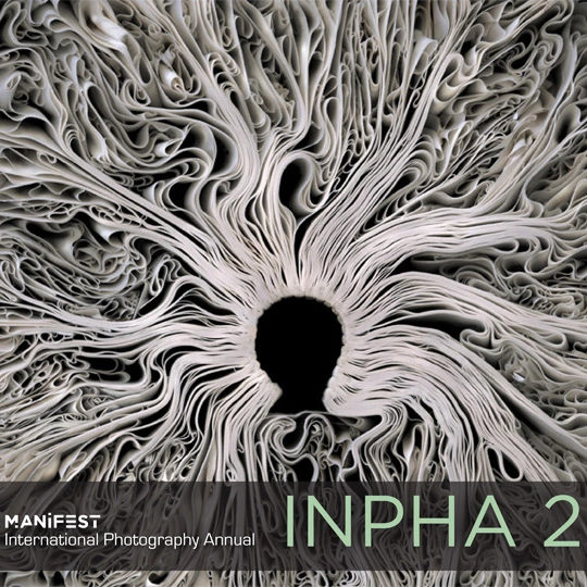 INPHA 2 cover design with pale, densely folded forms radiating around a dark central opening and the International Photography Annual title below.