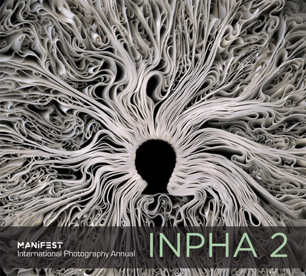 INPHA 2 cover design with pale, densely folded forms radiating around a dark central opening and the International Photography Annual title below.