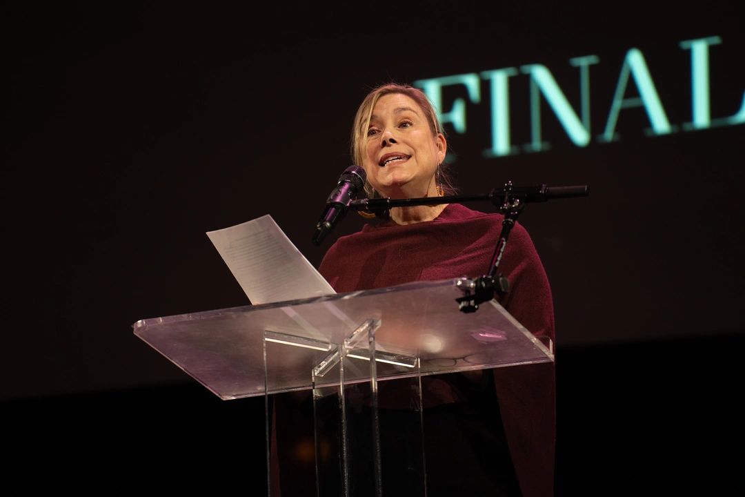 Ruth Dickey speaking at a lectern at the 2024 National Book Awards finalist reading.