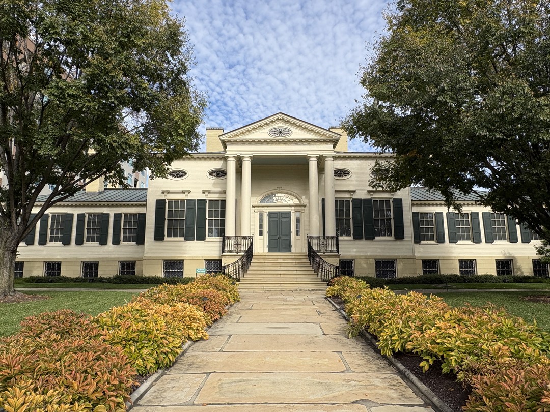 Frontal view of the historic Baum-Taft House, home of the Taft Museum of Art in Cincinnati, with its white Federal-style facade, tall columns and green shutters.
