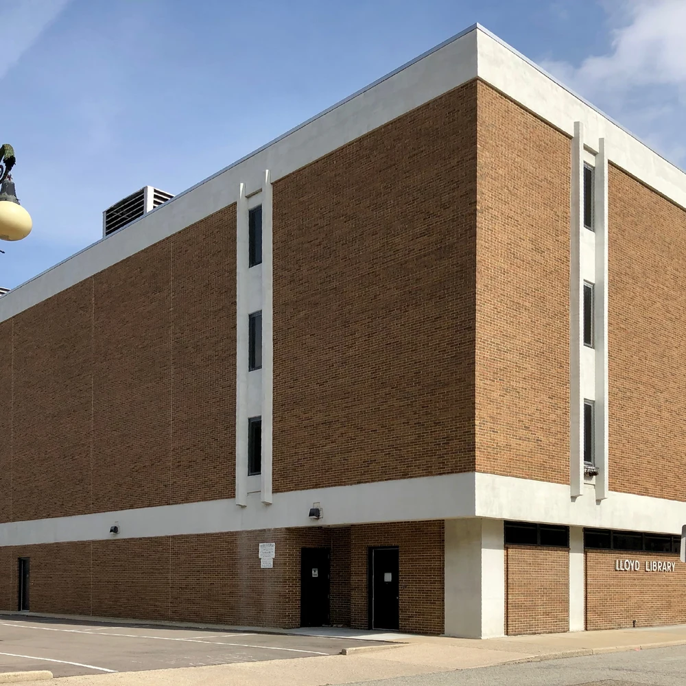 Brick facade of the Lloyd Library building in Cincinnati, its name on the wall, seen from the street corner.