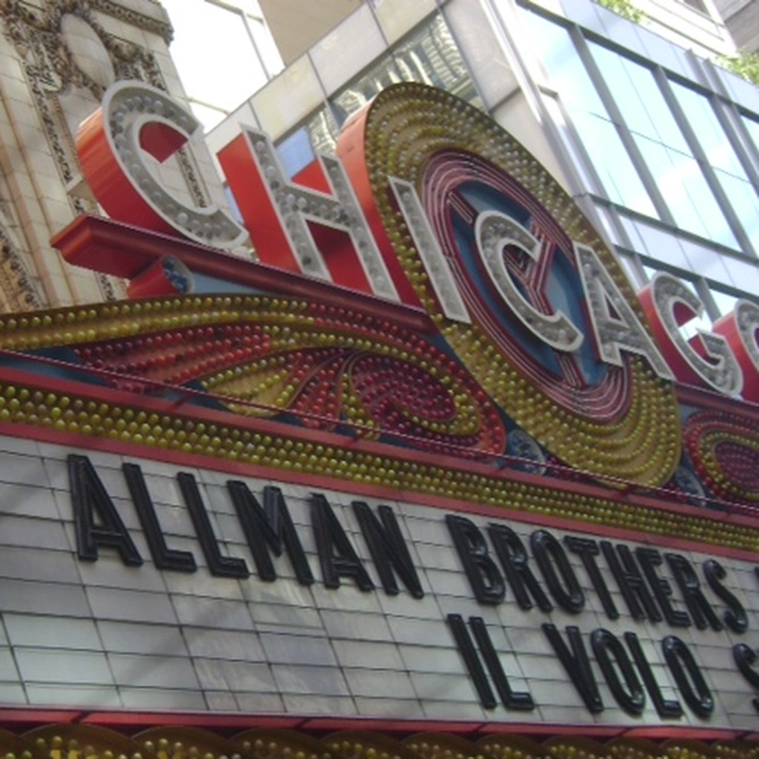 Square detail of the Chicago Theatre marquee: the illuminated vertical CHICAGO sign above the glowing marquee.