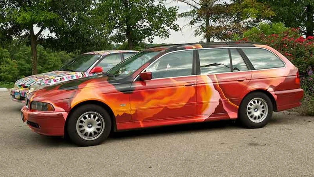 Red flame-painted BMW wagon with the Warhol Marilyn car behind it.