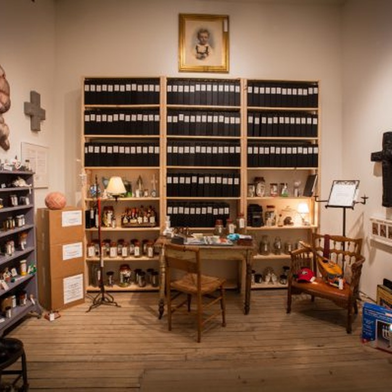 Detail of Louis Zoellar Bickett's archive installation showing shelves of catalogued objects
