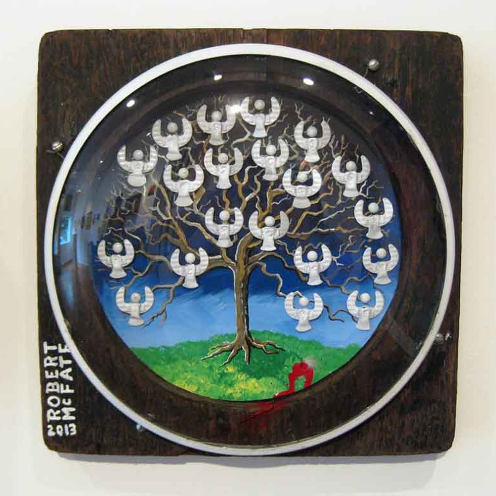 Circular painting of a tree with white angel figures against a blue sky, signed Robert McFate 2013
