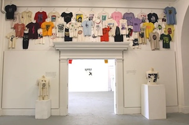 Installation view of RIPPED, curated by Cesar Padilla: a wall of vintage punk and post-punk t-shirts at LOT Louisville.
