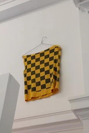 T-shirt on a hanger from RIPPED, curated by Cesar Padilla, El Campo de Mañana at LOT Louisville.