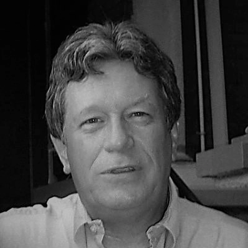 Black-and-white portrait photograph of the poet James Cummins, graying hair, wearing a light-colored collared shirt.