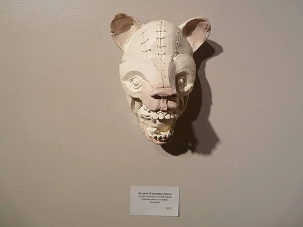 Eric Ehrnschwender, The game of necessary violence: white sculptural fox mask with stitched details.