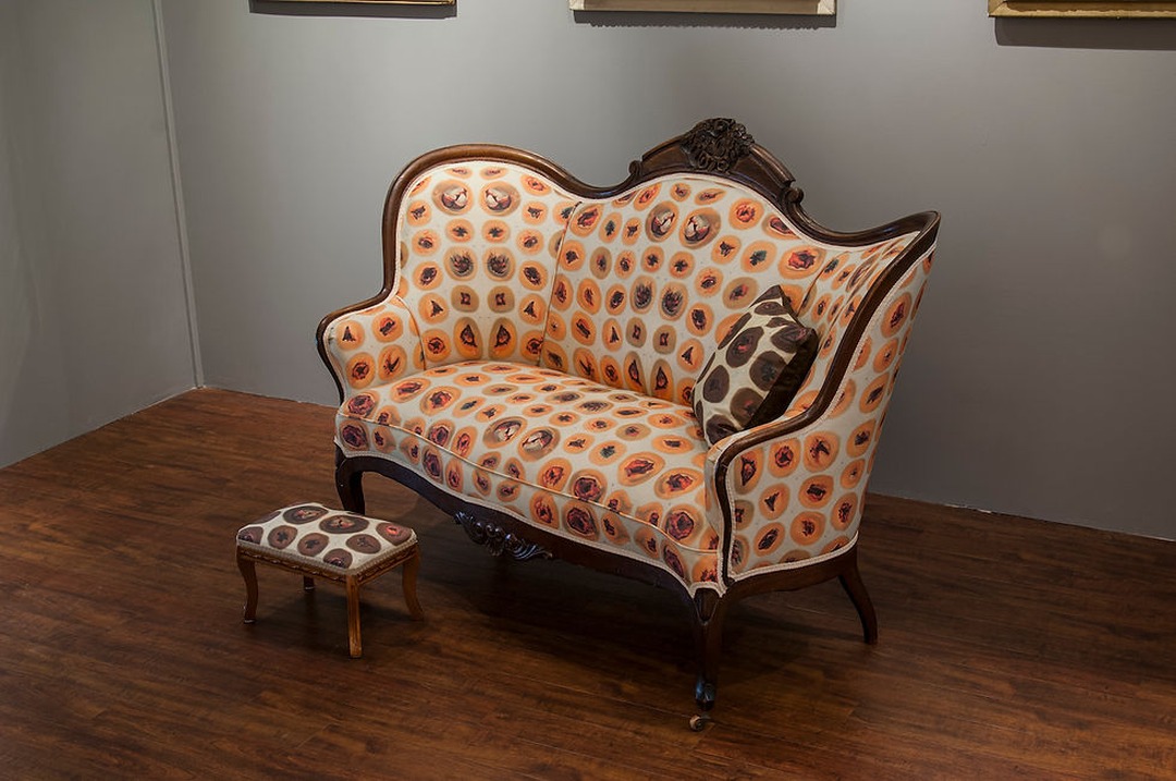 Detail of Kate Kern's Our Nation Mourns: Wounded Settee, Footstool, and Pillow, an ink-jet printed fabric on antique walnut settee