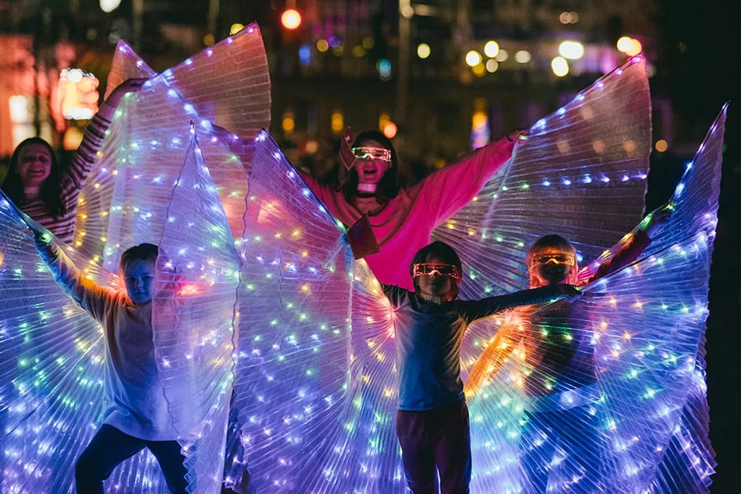 Performers with illuminated wings at BLINK, a Cincinnati arts festival.