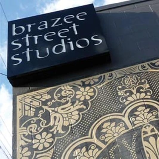 The Brazee Street Studios sign above a decorative patterned panel on the brick facade in Oakley, Cincinnati.