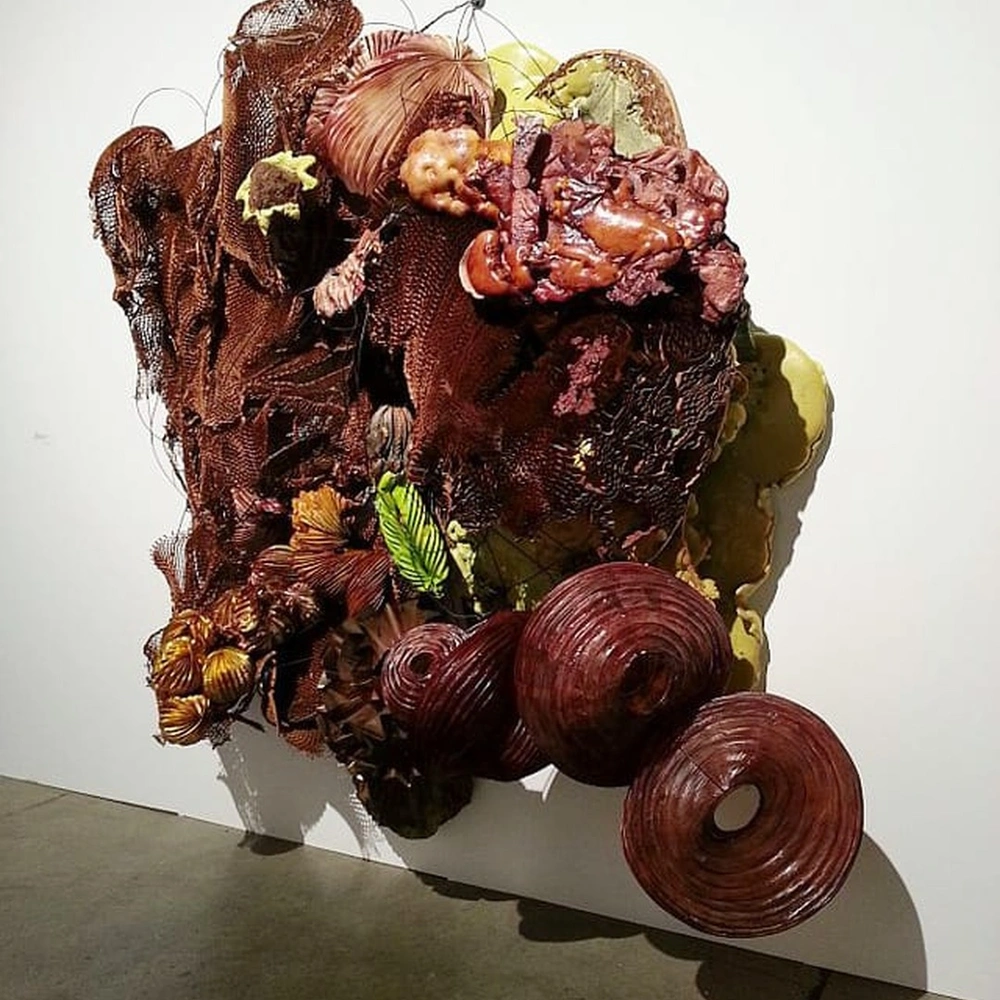 Judy Pfaff's wall sculpture Umidum (2013): layered reddish-brown and green organic forms, photographed at the Carl Solway Gallery booth, EXPO CHGO 2013.
