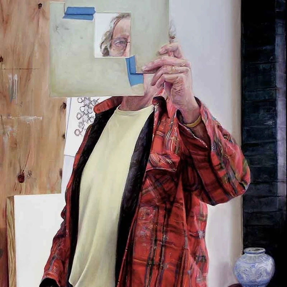 Detail of Cole Carothers' Livestrong (2005): a man in a red plaid shirt holding a board with a small taped face photograph.