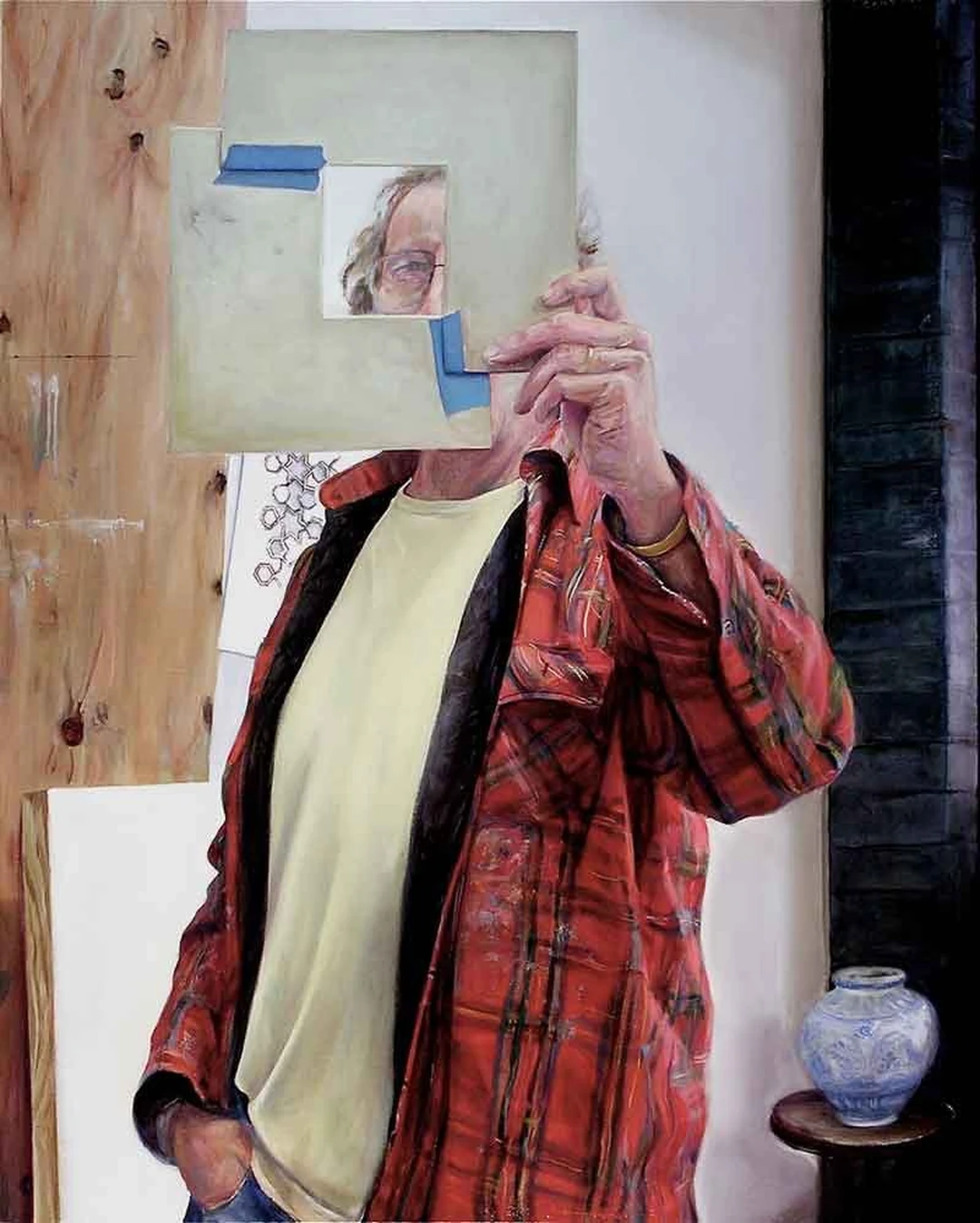Cole Carothers, Livestrong, 2005: oil painting of a man in a red plaid shirt holding up a large board with a small taped photograph of a face; a blue-and-white vase on a table at right.