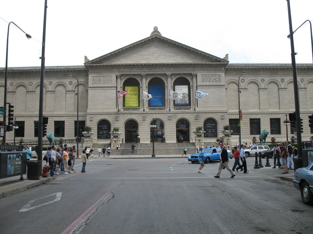 Front view of the Art Institute of Chicago building, with a stone lion flanking the entrance steps
