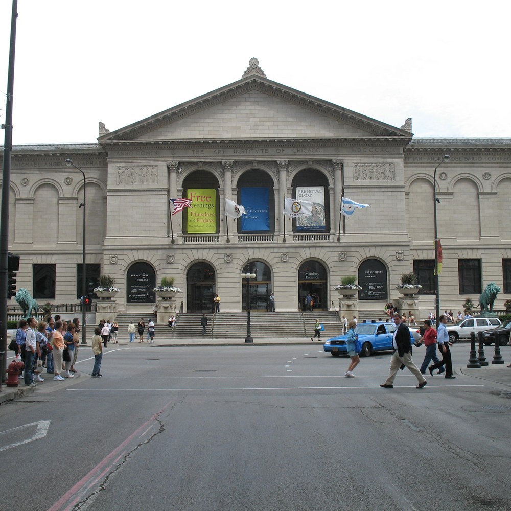 Front view of the Art Institute of Chicago building, with a stone lion flanking the entrance steps