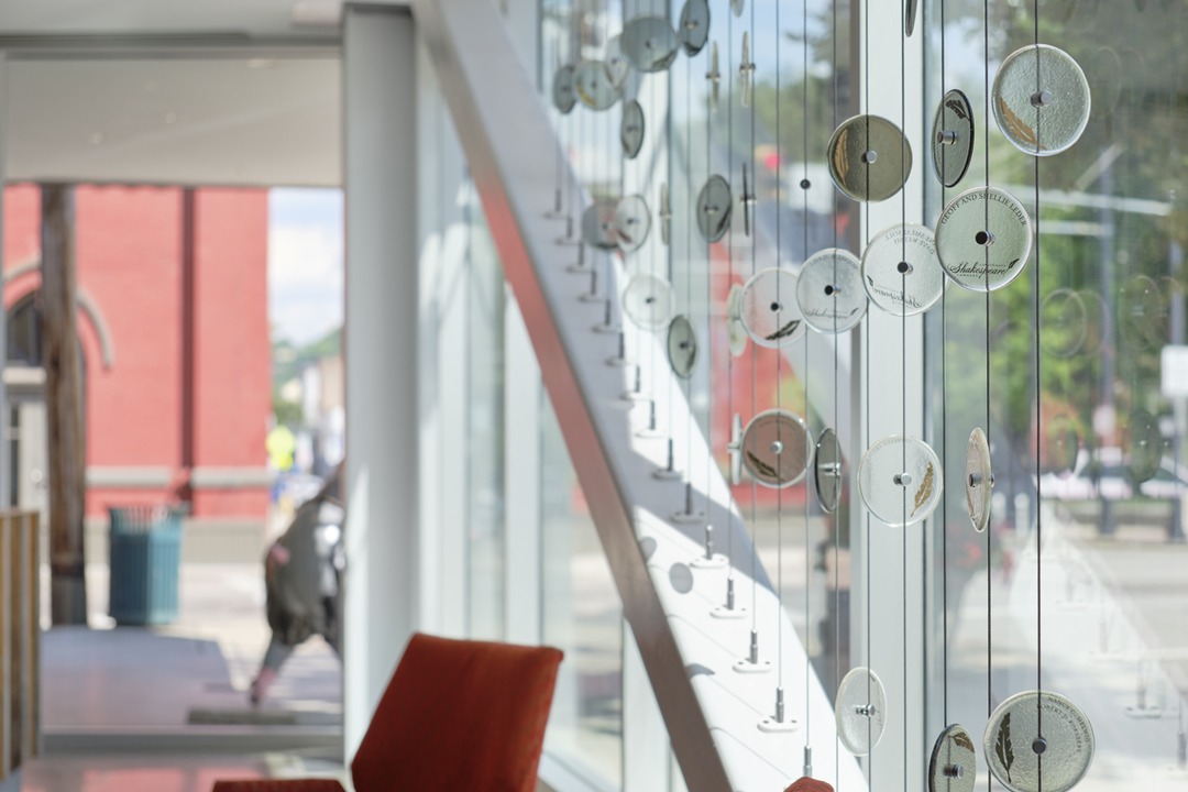 Hanging glass disc installation in the Brazee Street Studios interior