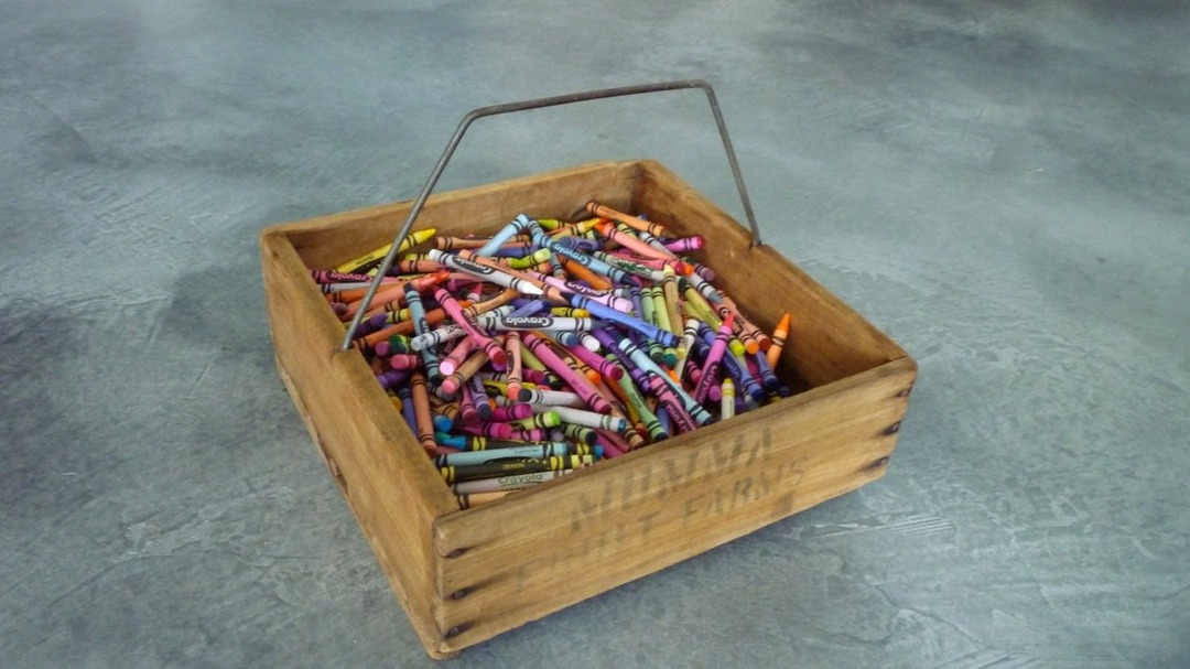 Wooden box full of colorful Crayola crayons