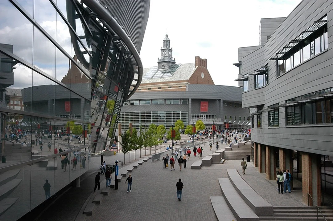 Pedestrians on Main Street at the University of Cincinnati, with the modern Steger Student Life Center on the right.