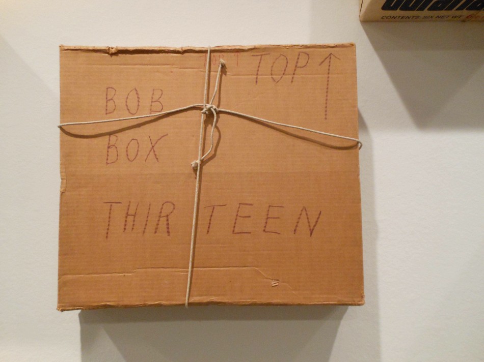 Close-up of a cardboard box labeled “Bob Box Thirteen” with “Top” and an arrow, tied with string. Photo: Cynthia Kukla.