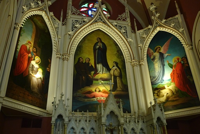 Johann Schmitt's altar murals in the Church of the Immaculata, Mt. Adams: saints in a Gothic triptych frame, with the Madonna and Child at the center and an angel with lambs at the right.