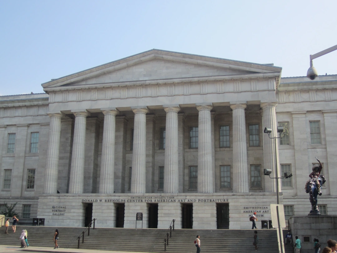 Front of the Greek Revival building that houses the National Portrait Gallery, with a pediment and a row of columns above the entrance steps.