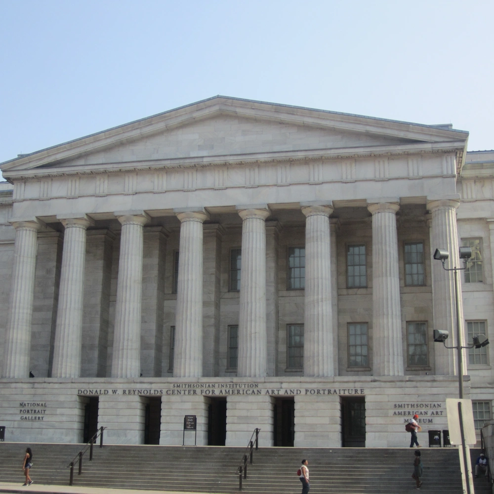 Front of the Greek Revival building that houses the National Portrait Gallery, with a pediment and a row of columns above the entrance steps.