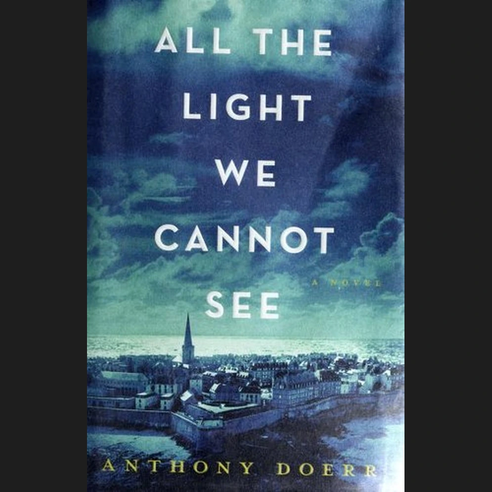 Dark teal book cover with the title in silver capitals above a seaside town and a church spire.
