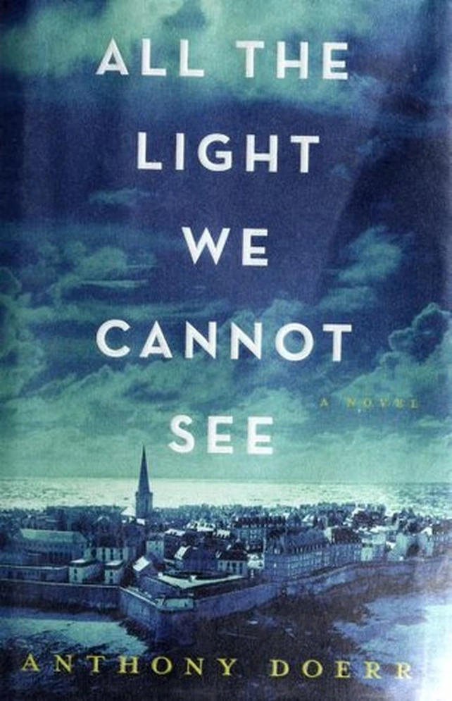 Dark teal book cover with the title in silver capitals above a seaside town and a church spire.