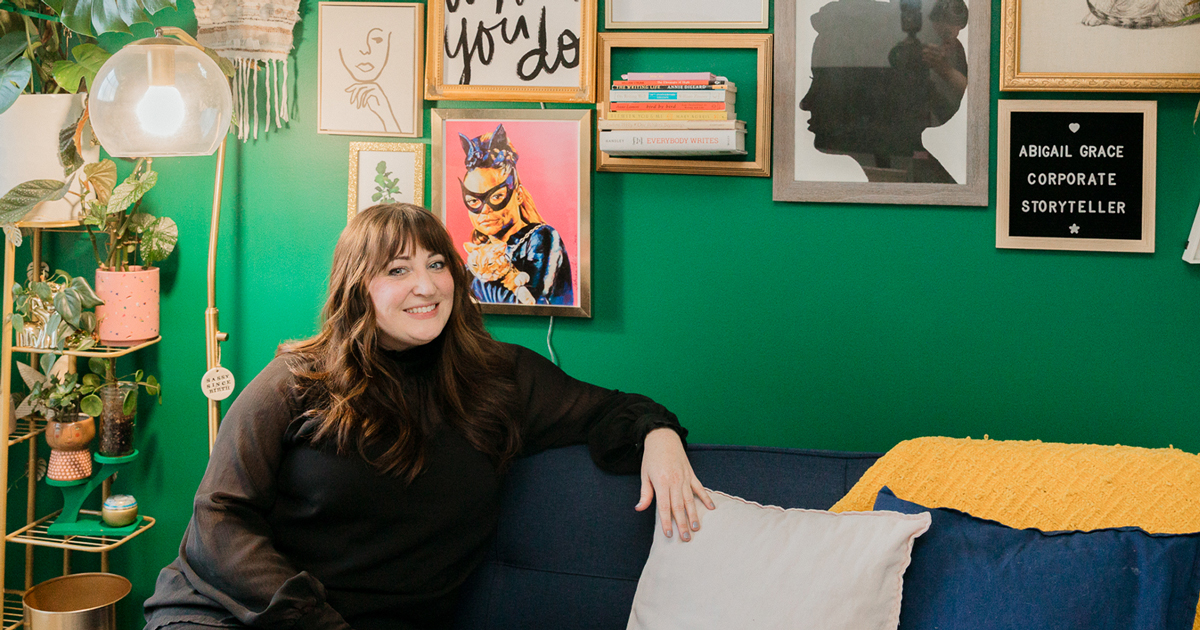Abigail Grace Writing owner Abigail Lind in her office with a green wall 